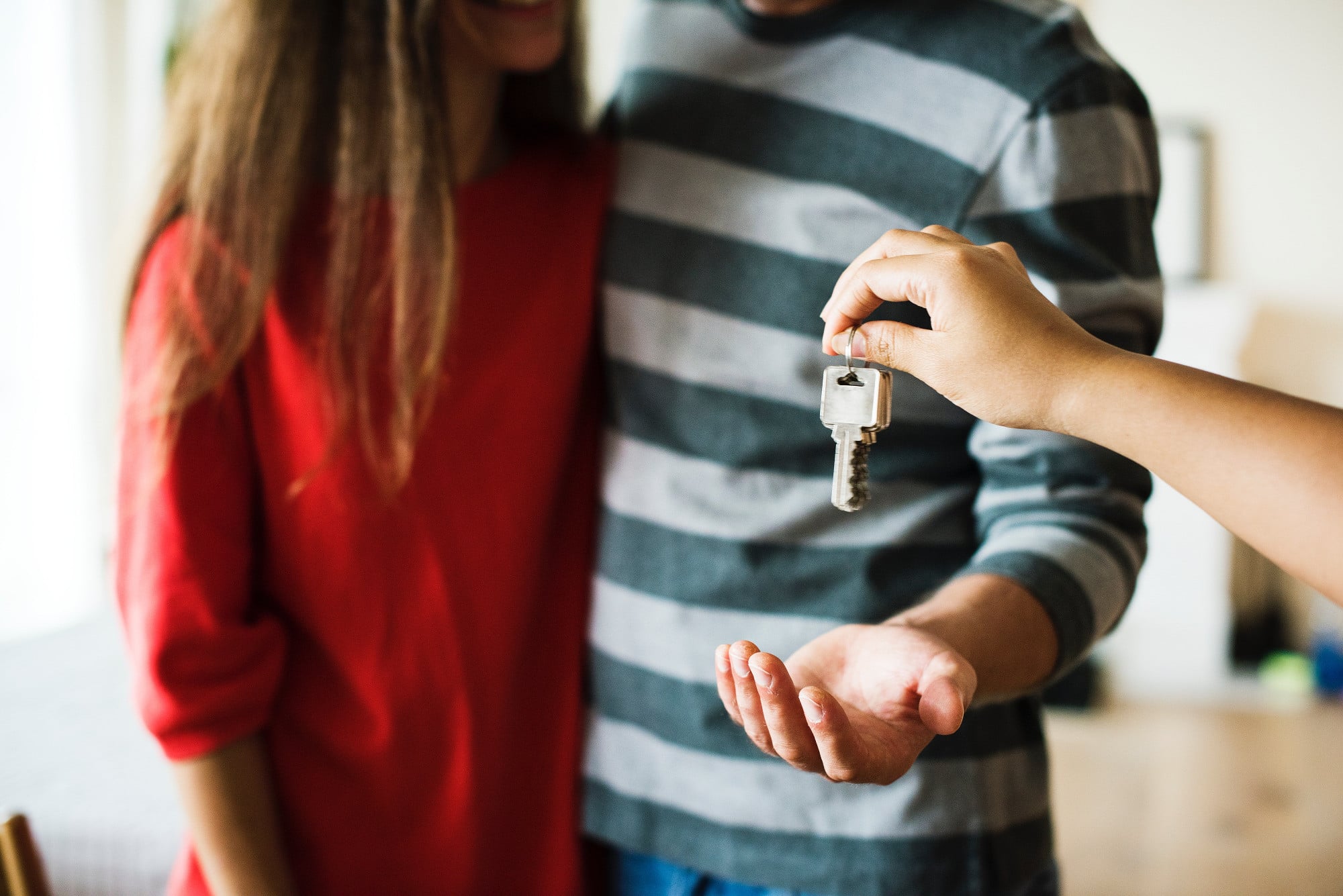 Couple being handed keys to property